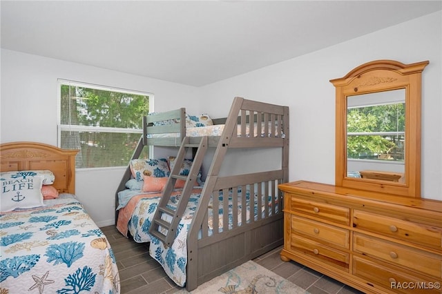 bedroom with dark hardwood / wood-style floors