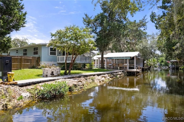 view of dock featuring a yard and a water view