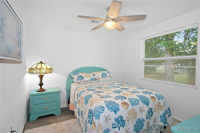 bedroom with ceiling fan and dark wood-type flooring