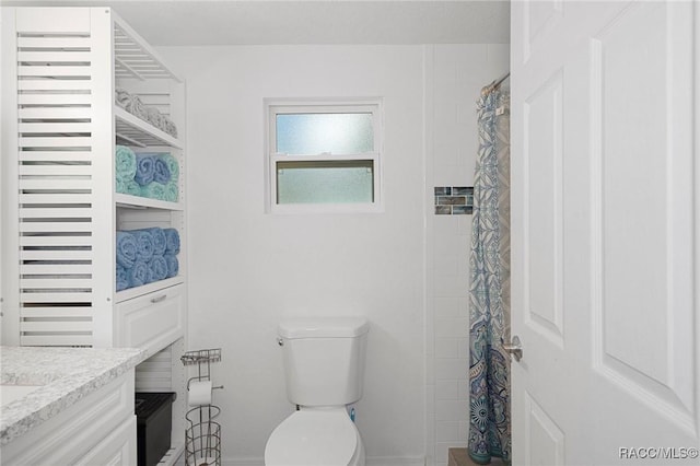 bathroom with a shower with curtain, vanity, and toilet