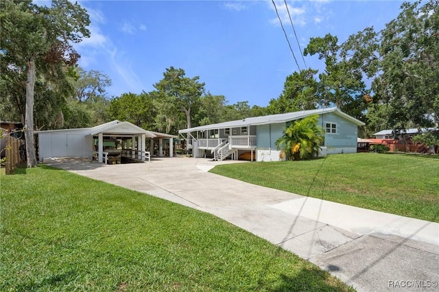 view of front of house with a front lawn and a carport