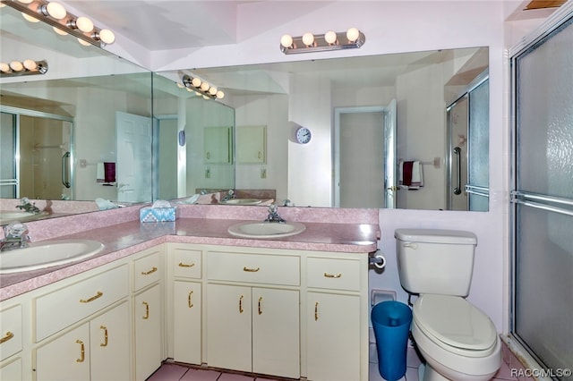 bathroom featuring vanity, tile patterned floors, and an enclosed shower