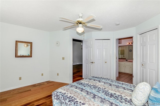 bedroom featuring ceiling fan, light hardwood / wood-style flooring, and ensuite bathroom