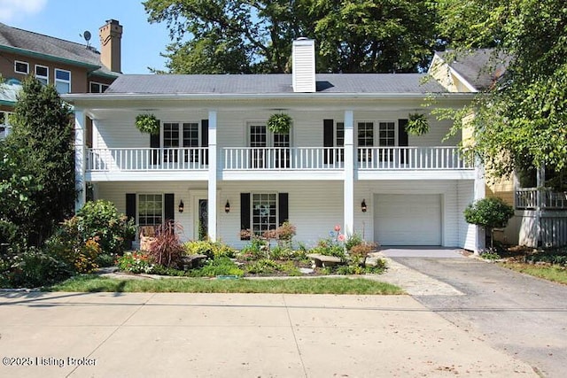 view of front of house featuring a garage and a balcony