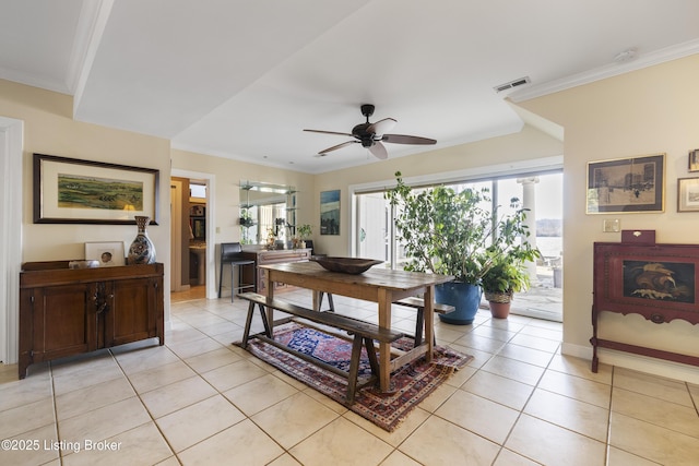 tiled dining area featuring crown molding and ceiling fan