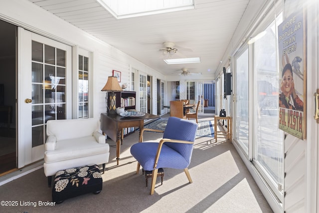 sunroom / solarium featuring ceiling fan and a skylight