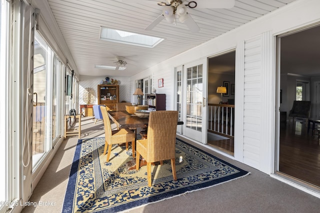 sunroom with ceiling fan and a skylight