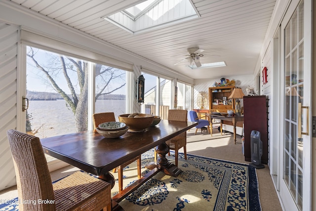 sunroom / solarium featuring a skylight, ceiling fan, and a water view