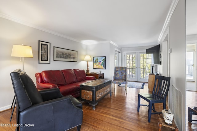 living room with dark hardwood / wood-style flooring, ornamental molding, and french doors