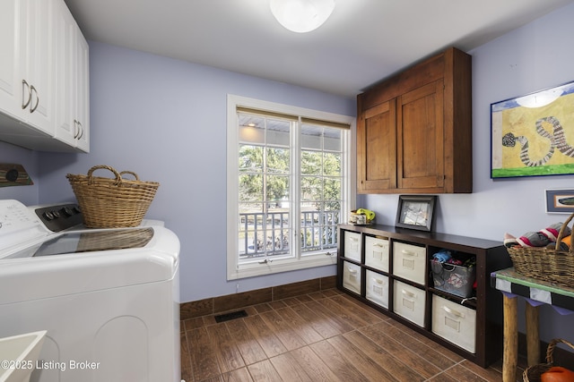 laundry room with cabinets, separate washer and dryer, and dark hardwood / wood-style flooring