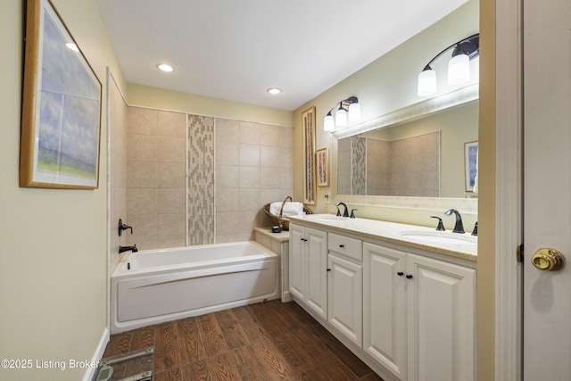 bathroom featuring vanity, hardwood / wood-style floors, and tiled shower / bath