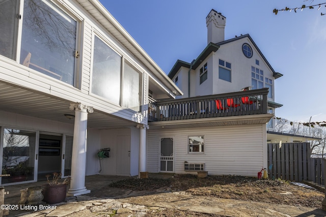 back of property with a balcony