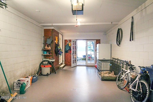 garage with a garage door opener and white fridge