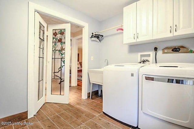 laundry room featuring independent washer and dryer and cabinets