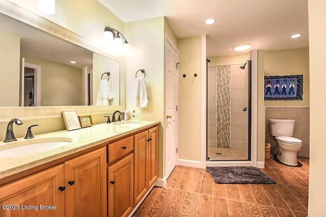 bathroom featuring vanity, toilet, and a tile shower