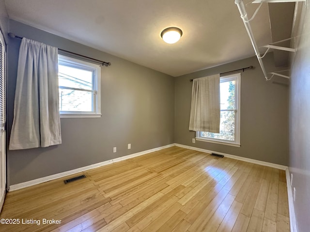 spare room featuring wood-type flooring