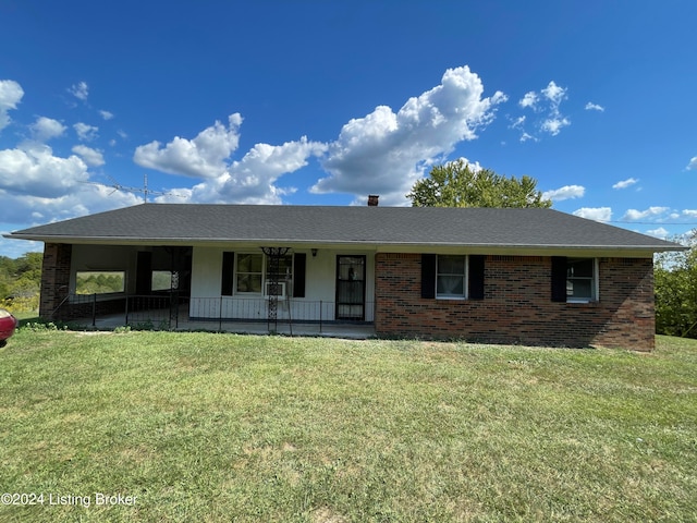 single story home featuring covered porch and a front yard