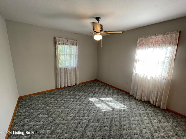 carpeted empty room featuring ceiling fan