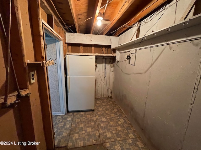 basement with white refrigerator