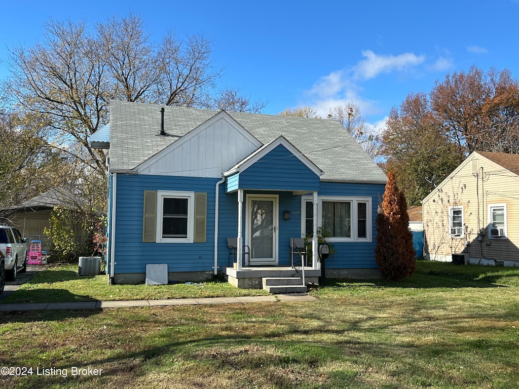 bungalow-style house featuring central AC and a front yard