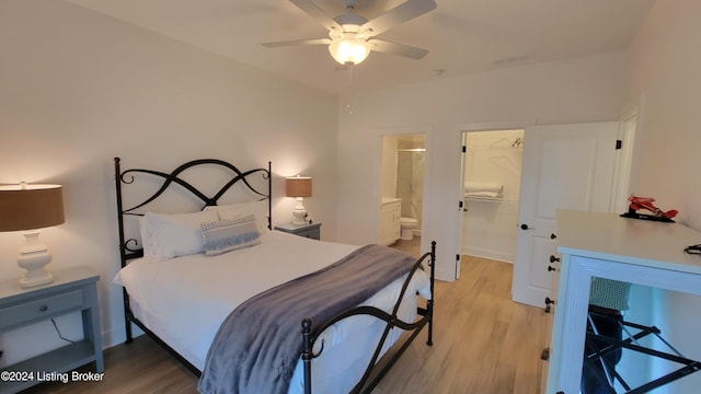 bedroom featuring a walk in closet, ensuite bath, ceiling fan, light hardwood / wood-style floors, and a closet