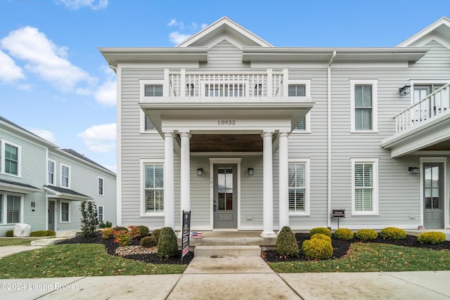 view of front of home featuring a balcony