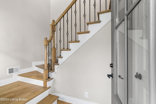 staircase with wood-type flooring