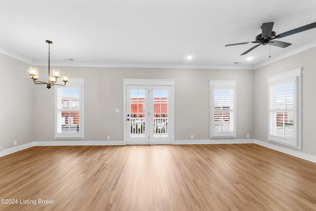 empty room with plenty of natural light, light hardwood / wood-style floors, and crown molding