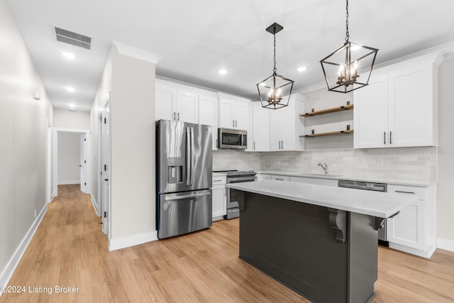 kitchen with light wood-type flooring, white cabinetry, and appliances with stainless steel finishes