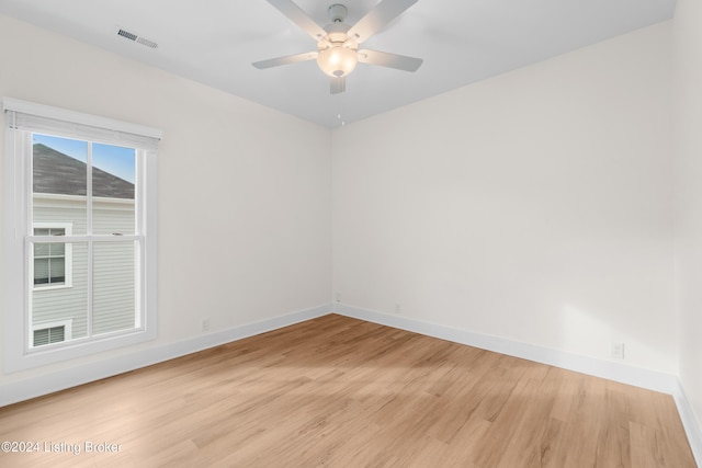 spare room featuring light hardwood / wood-style flooring and ceiling fan