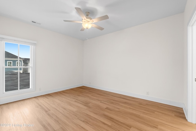 empty room with ceiling fan and light wood-type flooring