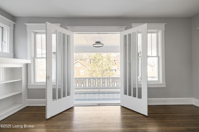 entryway with baseboards, wood finished floors, and french doors