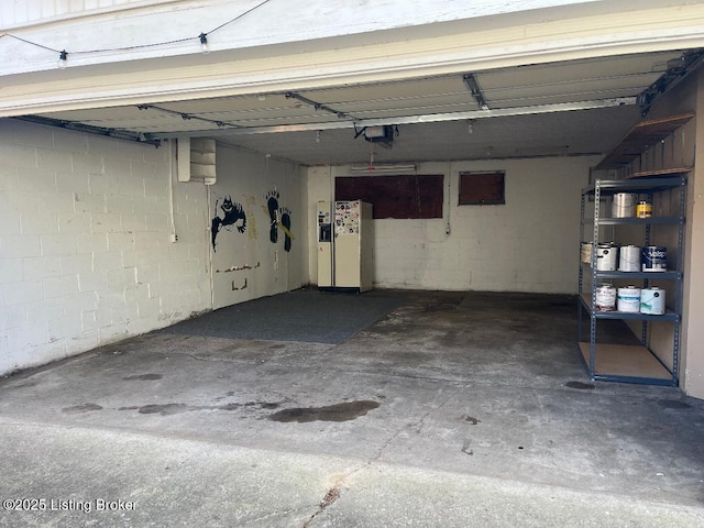 628 Harrison Ave, Louisville, KY 40217 - garage featuring a garage door opener and concrete block wall