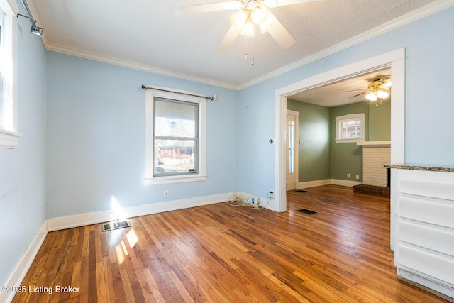 628 Harrison Ave, Louisville, KY 40217 - unfurnished room with ceiling fan, healthy amount of natural light, hardwood / wood-style flooring, crown molding, and baseboards