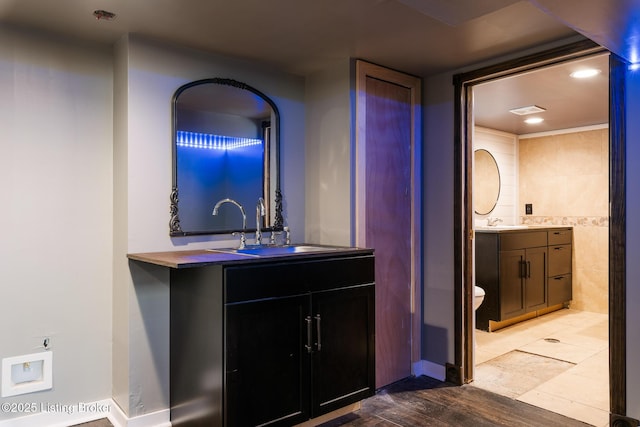 628 Harrison Ave, Louisville, KY 40217 - full bath featuring vanity, toilet, recessed lighting, baseboards, and wood finished floors