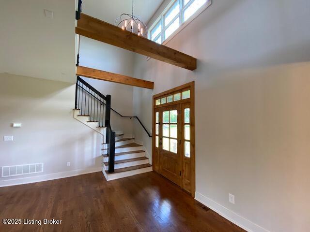300 Sadie Ln, Bardstown, KY 40004 - foyer featuring stairway, a chandelier, wood finished floors, a high ceiling, and baseboards