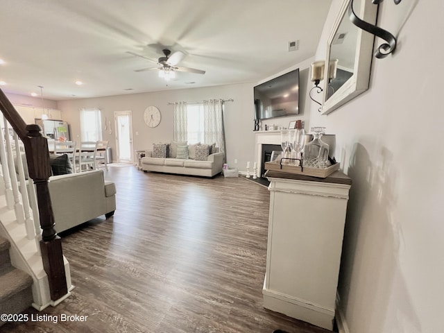 12023 Cascade Falls Trl, Louisville, KY 40229 - living area featuring a ceiling fan, stairs, dark wood-style floors, a fireplace, and recessed lighting
