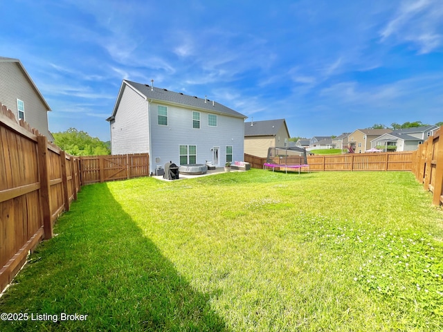 12023 Cascade Falls Trl, Louisville, KY 40229 - back of property featuring a trampoline, a patio area, a fenced backyard, and a residential view