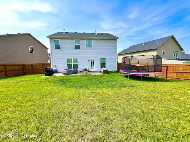 12023 Cascade Falls Trl, Louisville, KY 40229 - back of property with a trampoline, a patio area, and a fenced backyard