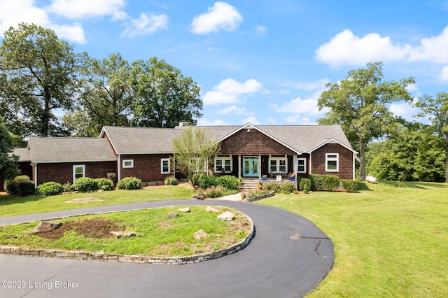 ranch-style home featuring a front yard