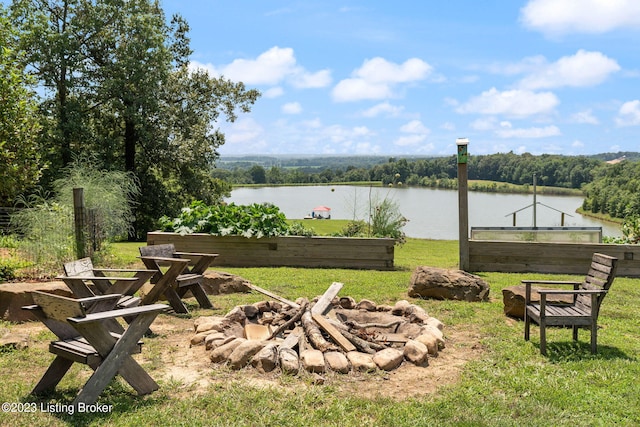 view of yard featuring a fire pit and a water view