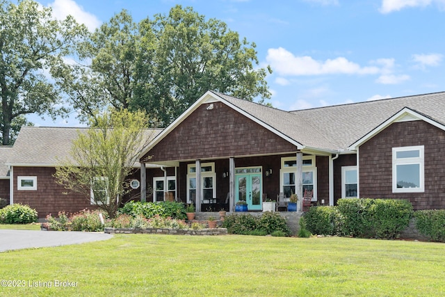 view of front of property with a front yard and french doors