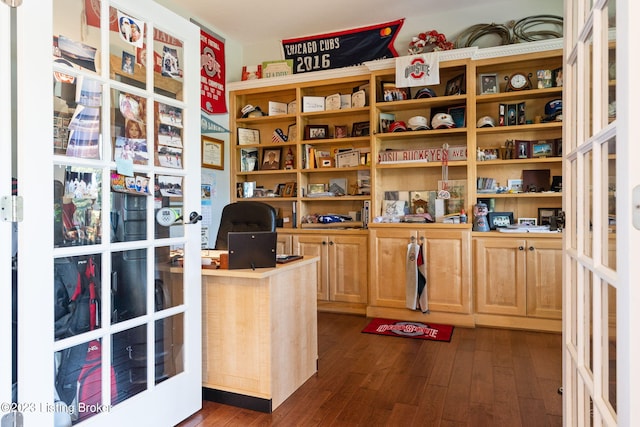 office space with built in desk, dark hardwood / wood-style floors, and french doors