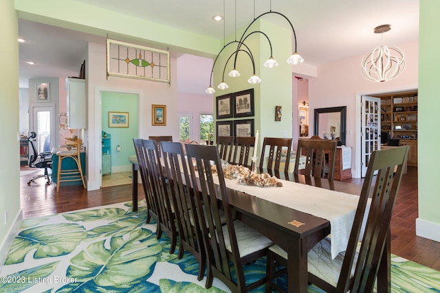 dining area featuring dark hardwood / wood-style floors and a notable chandelier