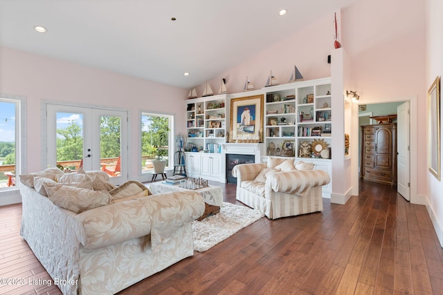 living room featuring high vaulted ceiling, french doors, and dark hardwood / wood-style flooring