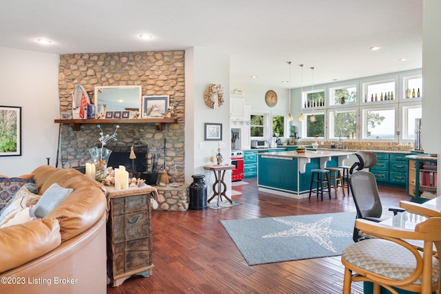 living room with dark hardwood / wood-style floors and a fireplace