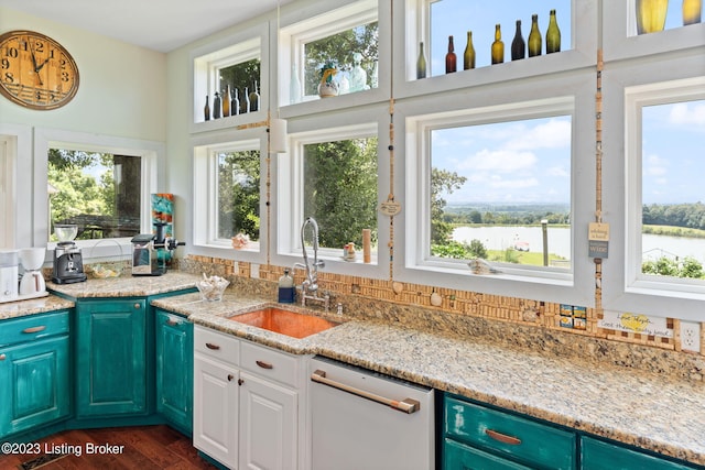 kitchen with dishwasher, dark wood-type flooring, sink, and a healthy amount of sunlight