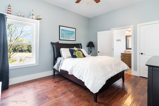 bedroom with connected bathroom, ceiling fan, and dark hardwood / wood-style flooring