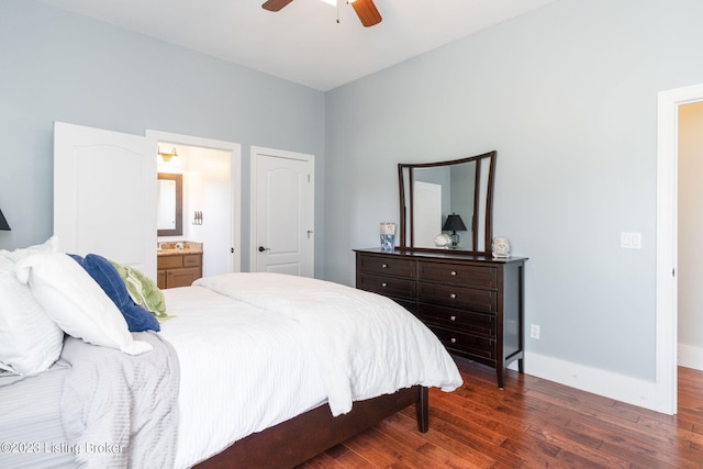 bedroom featuring ceiling fan, dark wood-type flooring, and ensuite bath