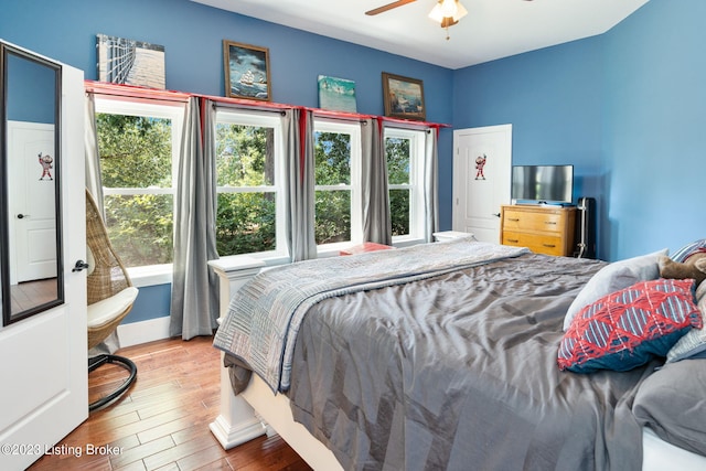 bedroom with ceiling fan and light wood-type flooring